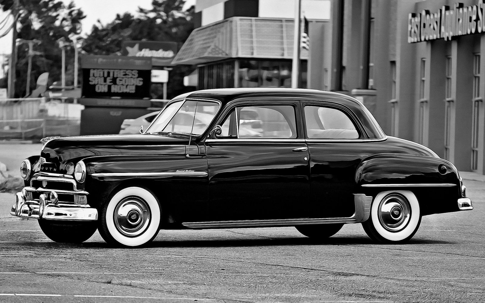 Classic Plymouth sedan parked beside a street