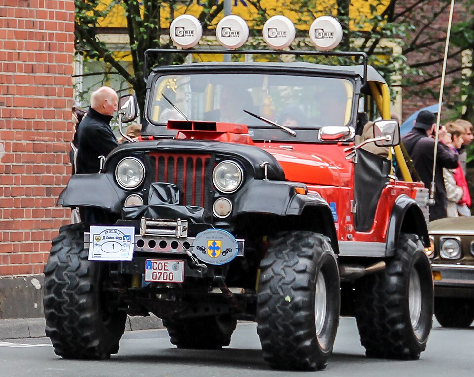 Red Jeep CJ-5 in a German parade