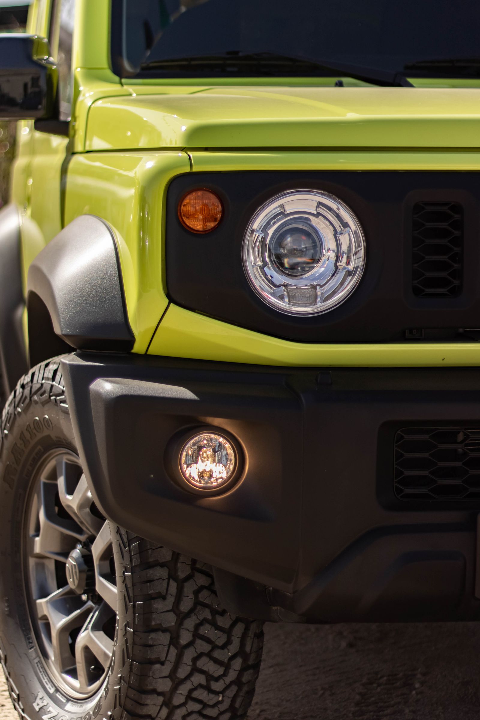 Green three-door Suzuki Jimny front detail