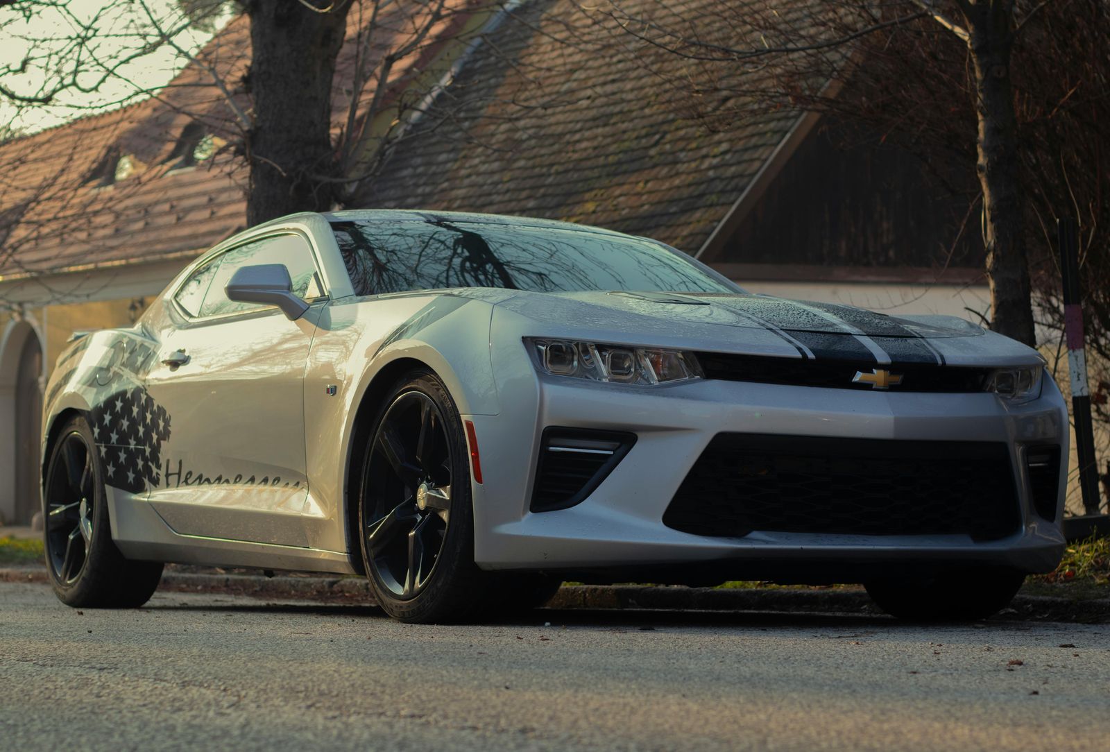 White sixth-generation Chevrolet Camaro in a city
