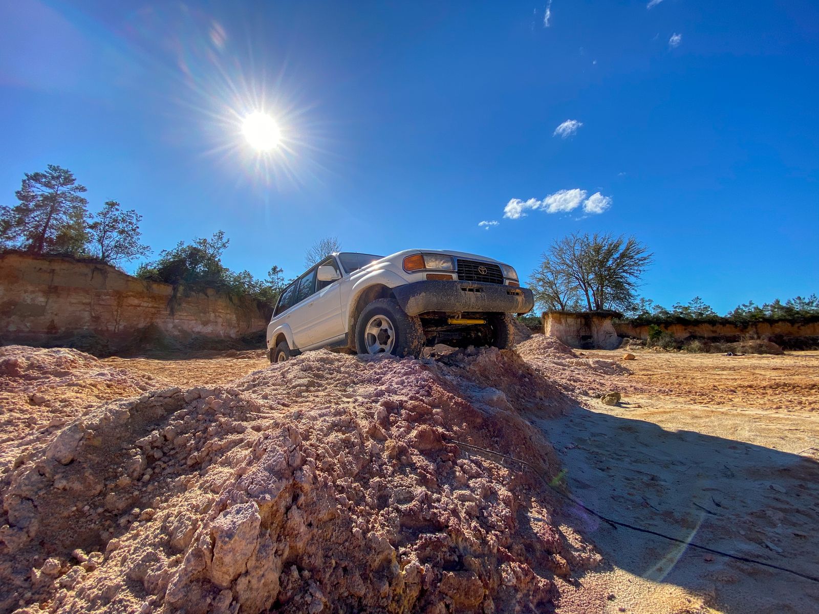 Toyota Land Cruiser 80 Series driving across uneven dirt in Florida